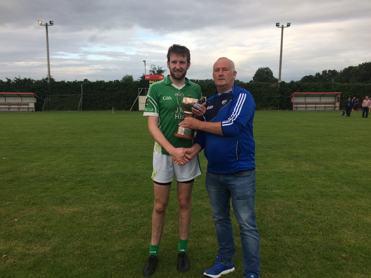 Ballyfin captain Ricky Quillinan accepts the cup